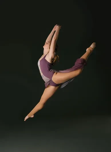 Contemporary dancer leaping with dramatic pose